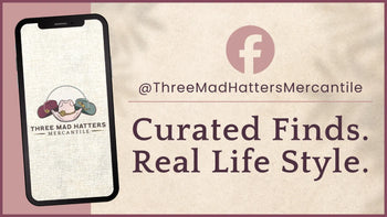 Promotional graphic for Three Mad Hatters Mercantile with phone displaying brand logo and text on a textured background | Three Mad Hatters Mercantile | Jackson, MS