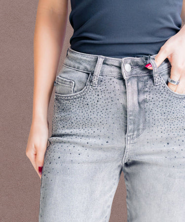 Person wearing gray speckled jeans with a plain background | Three Mad Hatters Mercantile