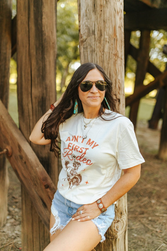 Ain't My First Rodeo Cowgirl Graphic Tee Graphic Tees   